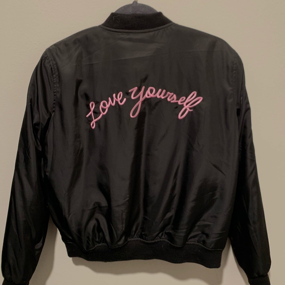 Black bomber jacket with pink print on the back